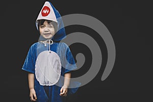 Child portrait with baby shark costume in studio