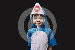 Child portrait with baby shark costume in studio