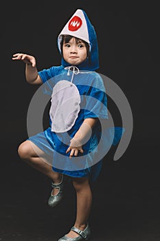 Child portrait with baby shark costume in studio