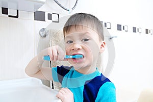 Child portrait brushing teeth, boy dental care, oral hygiene concept, child in bathroom with tooth brush