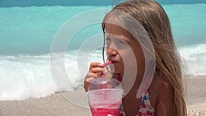 Child portrait drinking juice on beach, thirsty girl face view on seashore 4K