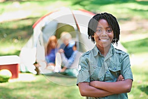 Child, portrait and happy on adventure at campground, joy and relaxing on vacation or holiday. Black male person