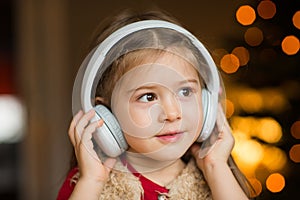 Child portrait in headphones listening to music