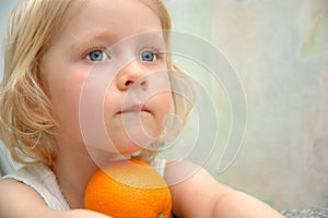 Child portrait with orange fruit