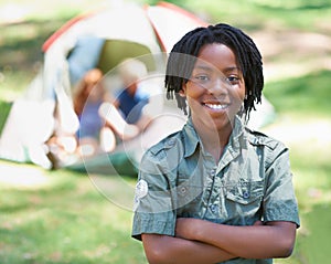 Child, portrait and smile on adventure at campground, happy and relaxing on vacation or holiday. Black male person