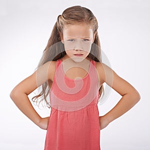 Child, portrait and unhappy grumpy in studio or bad mood discipline or development, trouble or angry. Female person