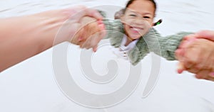 Child, pov and swinging from hands at the beach with a parent in fun game. Face, smile and girl swing or playing with