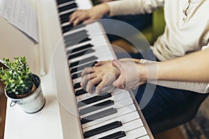 Child practicing on the modern electric piano at home. Music lesson