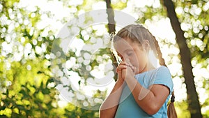 Child pray. Young gratitude a god religion concept lifestyle. Little girl in nature outdoors praying dreams of happiness