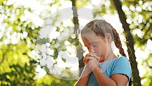 child pray. young gratitude lifestyle a god religion concept. little girl in nature outdoors praying dreams of happiness