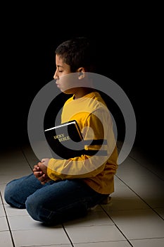 Child Praying with Bible