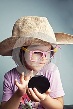 Child preens in a cowboy hat