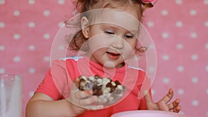 A child prepares breakfast for himself cereal with yogurt. Baby girl and eats food