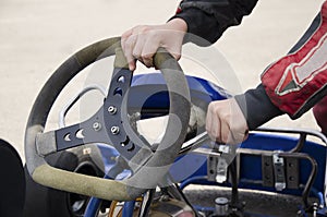 A child prepares a go-kart car for racing