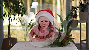 child is preparing for Christmas. New Year's crafts for the holiday. Children game with fir fetishes and balls. Little