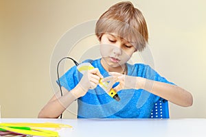 Child preparing to use 3D printing pen to made an item. Creative, technology, leisure, education concept