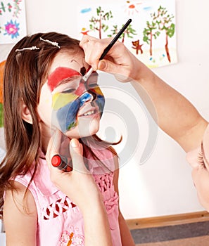 Child preschooler with face painting. photo