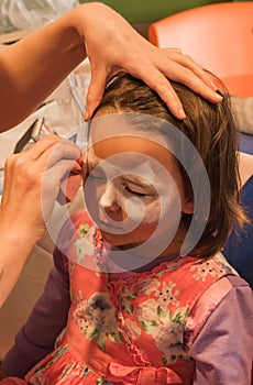 Child preschooler with face painting. Make up.
