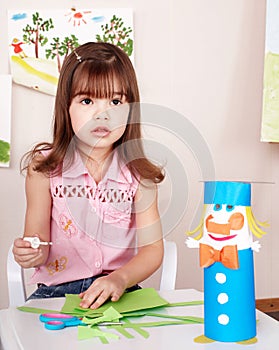 Child preschooler play glue in classroom. photo