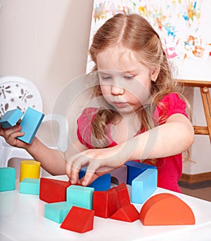 Child preschooler play wood block.