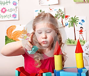 Child preschooler play wood block.