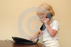 Child presses telephone buttons