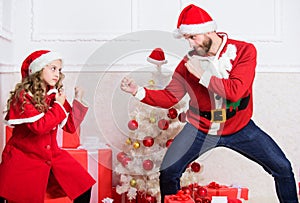 Child pretend to fight for christmas gifts. Christmas games. Make it fun. Kid cute girl play with father near christmas