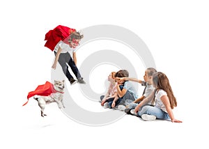 Child pretending to be a superhero with his super dog and friends sitting around