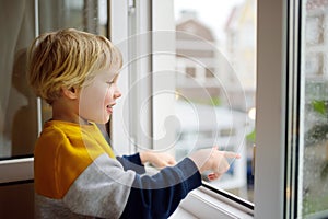 A child of primary school age is at risk of falling from a window from a great height