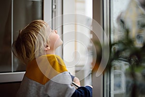 A child of primary school age is at risk of falling from a window from a great height