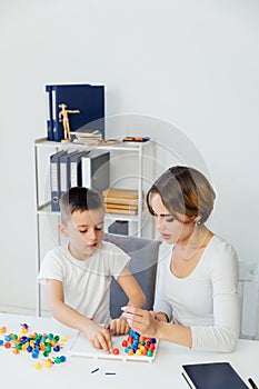 a child psychologist is engaged with a child in the office