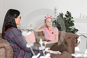 Child psychologist talking with a teenage girl in his office. Psychological assistance to children. Teenager girl smiling