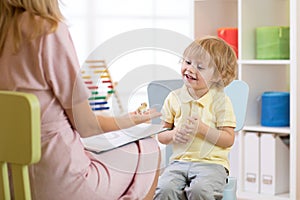 Child psychologist working with kid boy