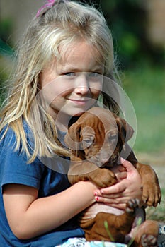 Child with puppy pet