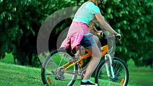 Child put on bicycle helmet teach ride bike in park