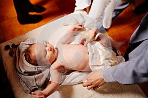 The child is put on clothes on a table in the Church. the ordinance of baptism.