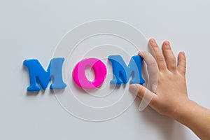 The child put the word MOM in magnetic letters. Early development.