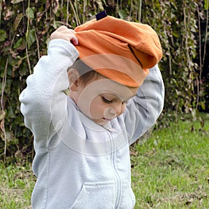 Child putting on hat