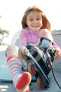 Child putting on her rollerblade skate photo