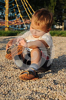 Child putting his shoes on