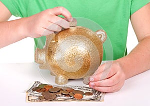 Child putting money in piggy bank