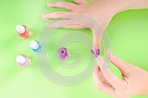 Child putting on nail polish