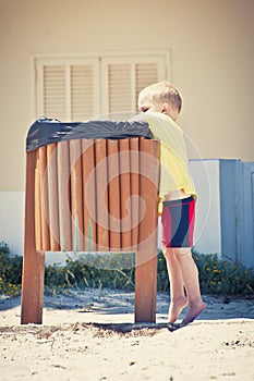 Child putting waste in the bin