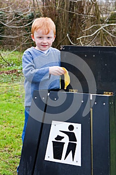 Child putting waste in bin