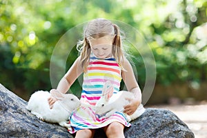 Child with rabbit. Easter bunny. Kids and pets.