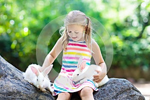 Child with rabbit. Easter bunny. Kids and pets.