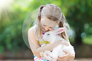 Child with rabbit. Easter bunny. Kids and pets.