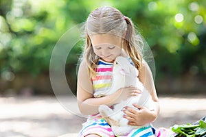 Child with rabbit. Easter bunny. Kids and pets.