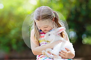 Child with rabbit. Easter bunny. Kids and pets