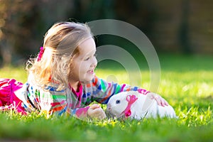 Child with rabbit. Easter bunny. Kids and pets